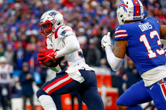 New England Patriots safety Devin McCourty (32) runs back an interception during the first half of an NFL football game against the Buffalo Bills, Sunday, Jan. 8, 2023, in Orchard Park.